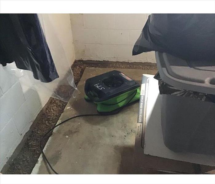SERVPRO equipment in basement with items in a bin