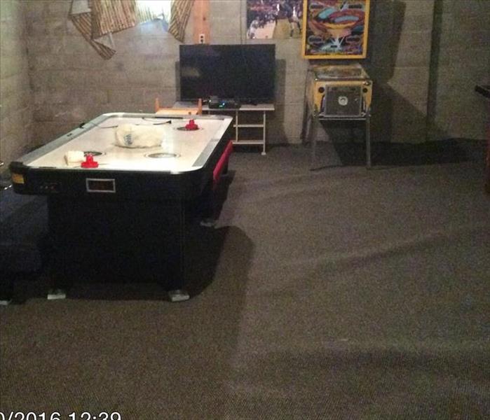 basement with wet grey carpeting and an air hockey table