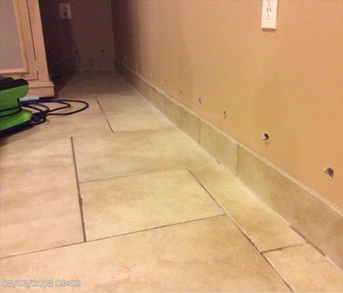 tile floor with water showing in the grout lines