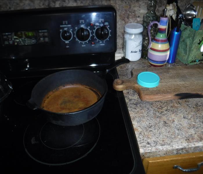 Grease fire in a cast iron pan on stovetop
